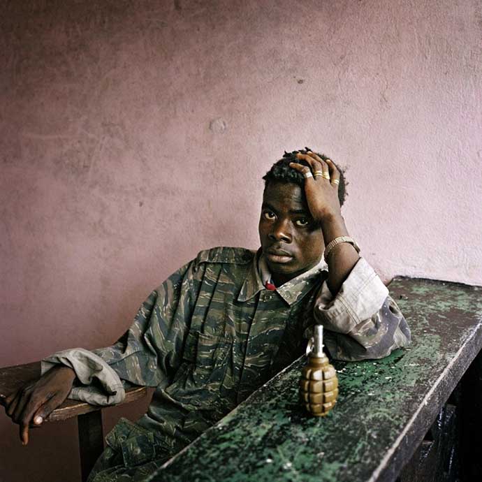 Young rebel fighter and hand grenade.16.06.03. Tubmanberg. Liberia.